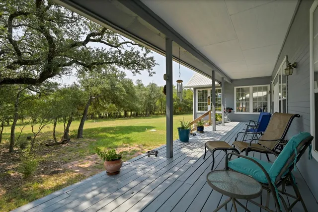 a view of swimming pool with chairs and table in patio
