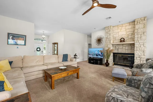 a living room with furniture and a fireplace