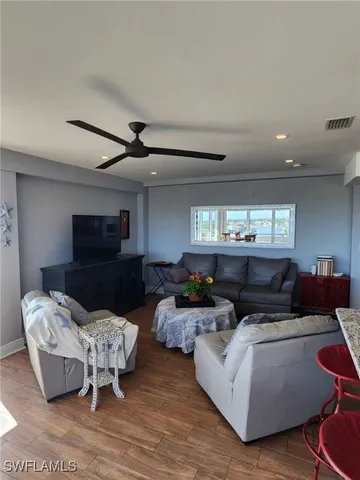 a bedroom with a bed and a dresser next to a window