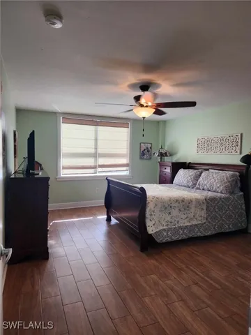 a view of walk in closet and wooden floor