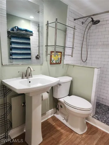 a bathroom with a shower toilet and sink