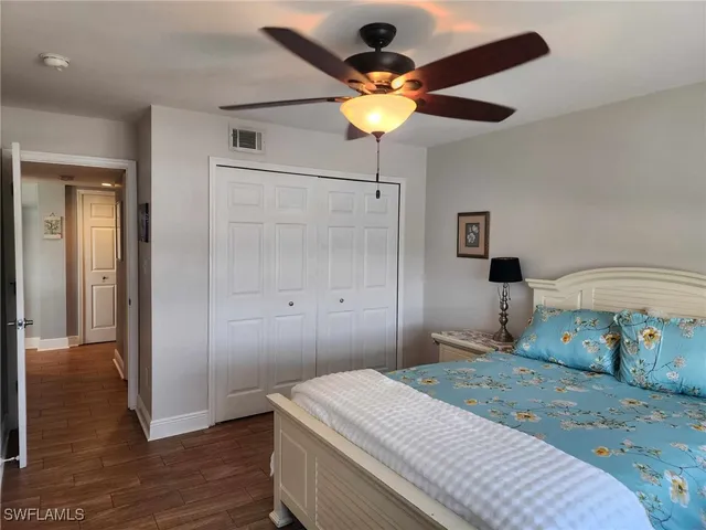 a bathroom with a white toilet sitting next to a white sink and vanity