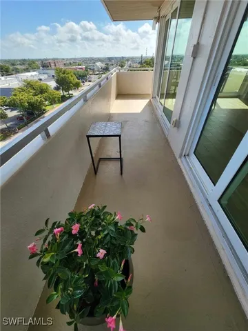 a view of a balcony with furniture
