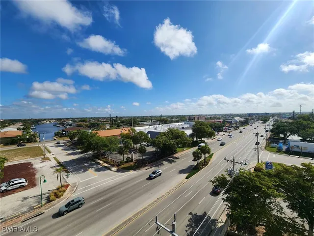 a view of ocean with boats and trees in the background