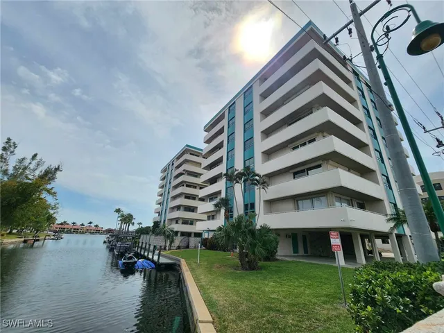 a view of a lake with boats and trees in the background