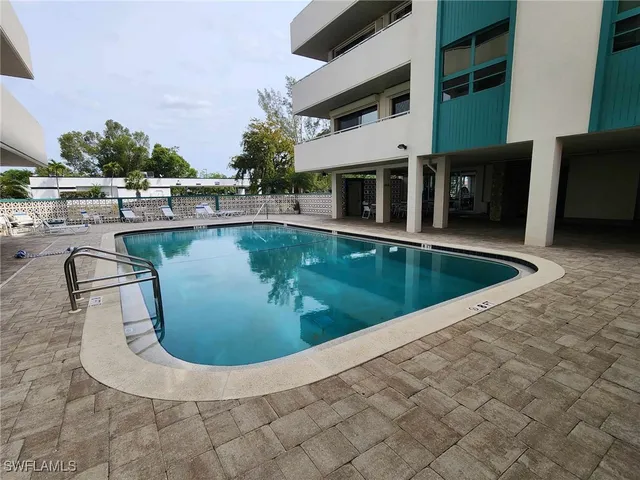 a spacious bedroom with a bed and a wooden floor