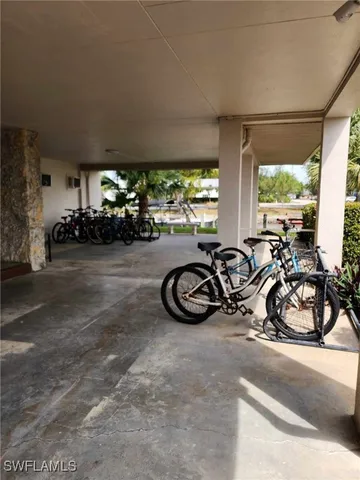 a view of a cars park in front of a building