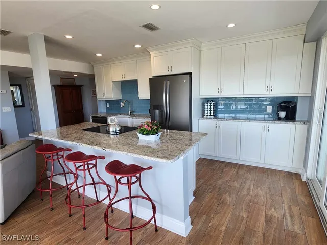 a view of a dining room with furniture large windows and wooden floor