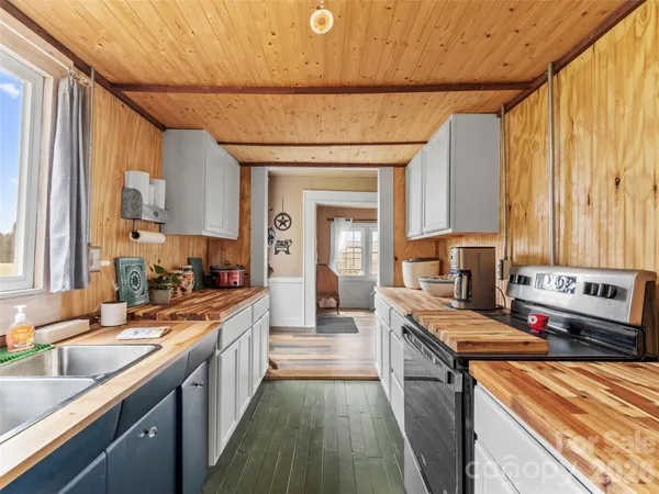 a kitchen with stainless steel appliances a sink stove and cabinets