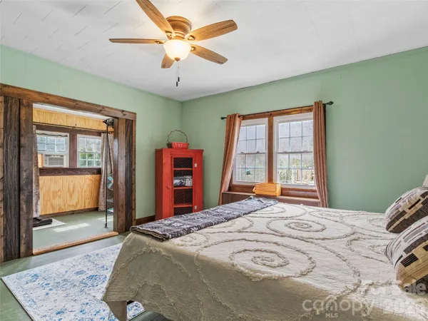 a bedroom with a large bed and a chandelier