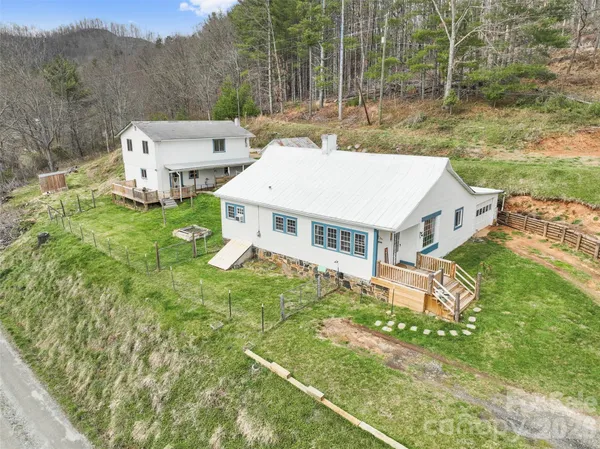 an aerial view of a house with a yard table and chairs