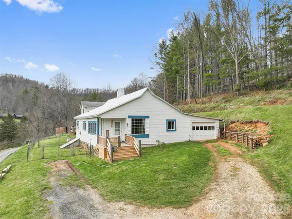 a view of a house with a backyard and a patio