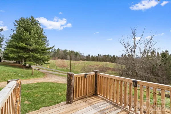 a view of a wooden deck with lake view