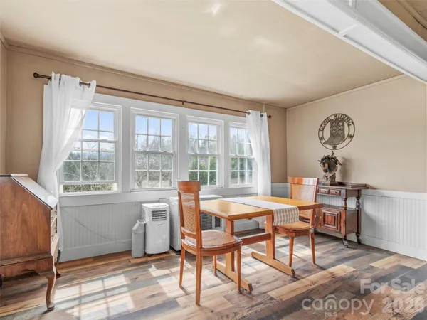 a dining room with furniture and window