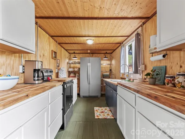 a kitchen with refrigerator and window