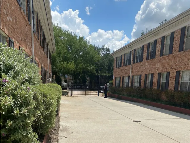 a front view of a house with garden and trees