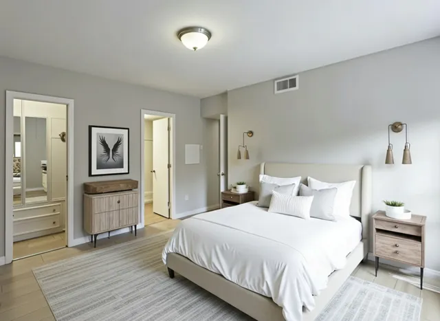 a bedroom with a bed and wooden floor