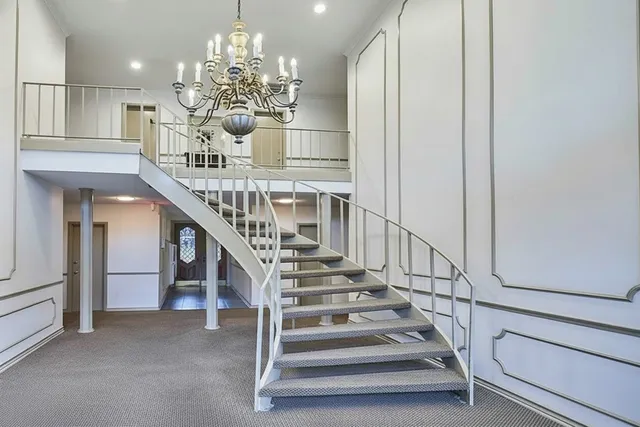 a view of a staircase and kitchen view