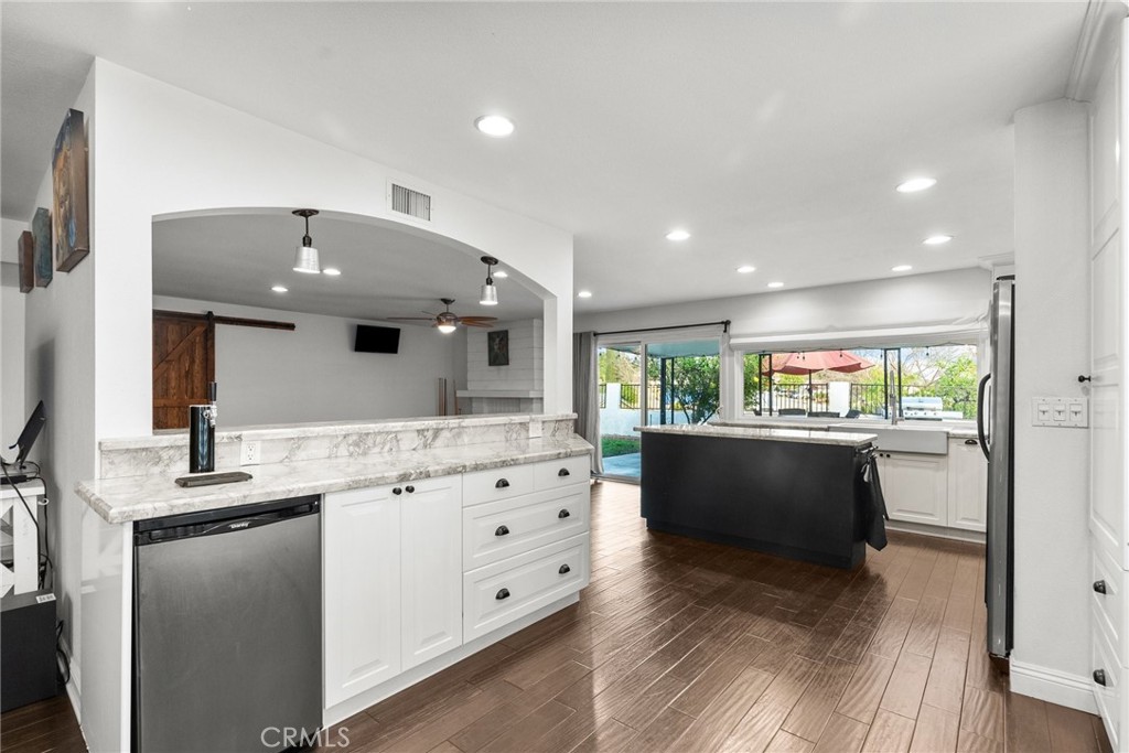 2804 Big Sky Place Simi Valley, CA 93065 - Photo 14 of 36 a large kitchen with stainless steel appliances kitchen island granite countertop a sink and cabinets