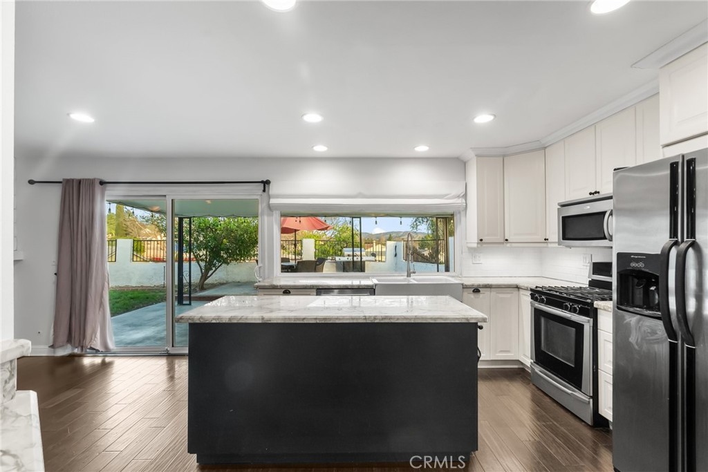 2804 Big Sky Place Simi Valley, CA 93065 - Photo 15 of 36 a kitchen with stainless steel appliances granite countertop a stove a sink and a refrigerator