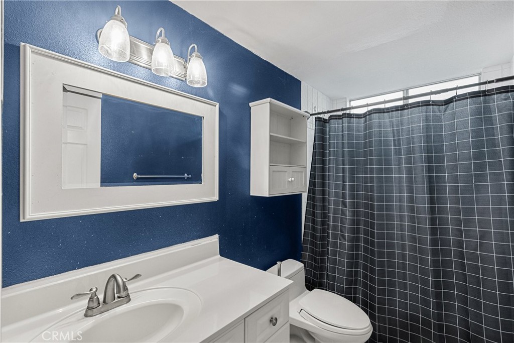 2804 Big Sky Place Simi Valley, CA 93065 - Photo 26 of 36 a bathroom with a toilet a sink and mirror