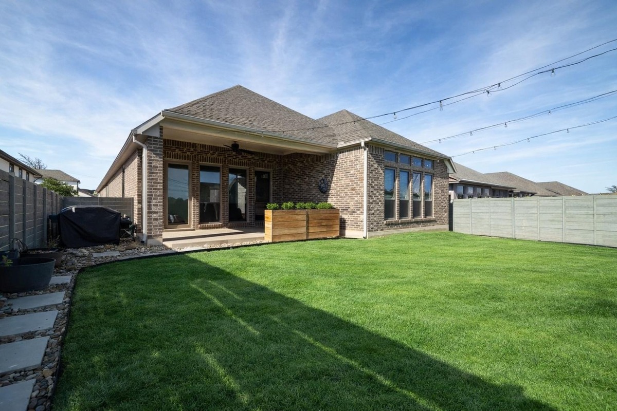 1136 Stetson Hat Trail Georgetown, TX 78628 - Photo 11 of 40 a front view of a house with a garden