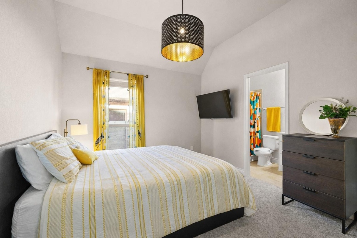 1136 Stetson Hat Trail Georgetown, TX 78628 - Photo 16 of 40 a bedroom with a bed and a flat screen tv