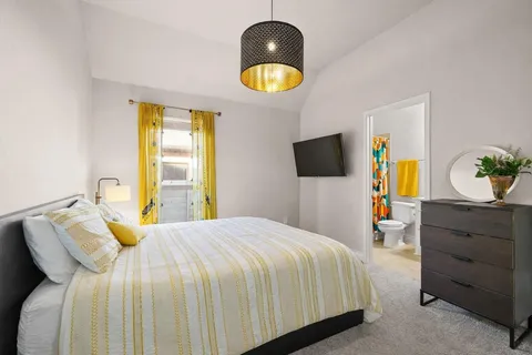 a bedroom with a bed and a flat screen tv