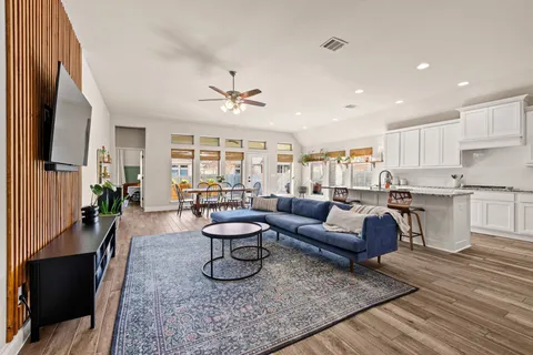 a living room with furniture and a wooden floor