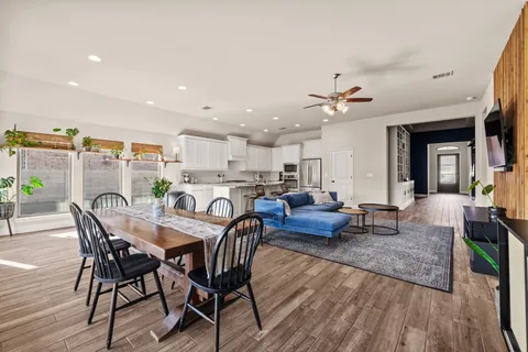 a view of a dining room with furniture and wooden floor
