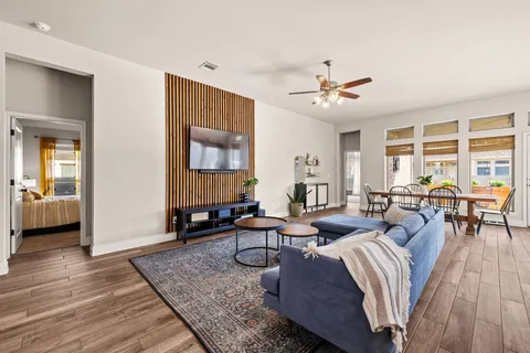 a living room with furniture and wooden floor