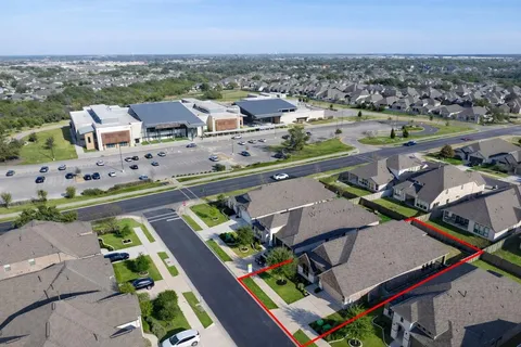 an aerial view of a house with yard