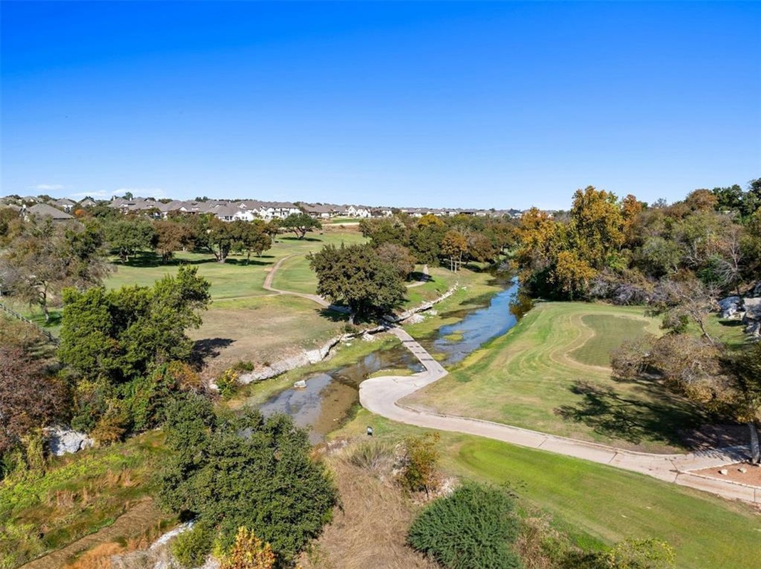 1136 Stetson Hat Trail Georgetown, TX 78628 - Photo 37 of 40 a view of a lake with a yard