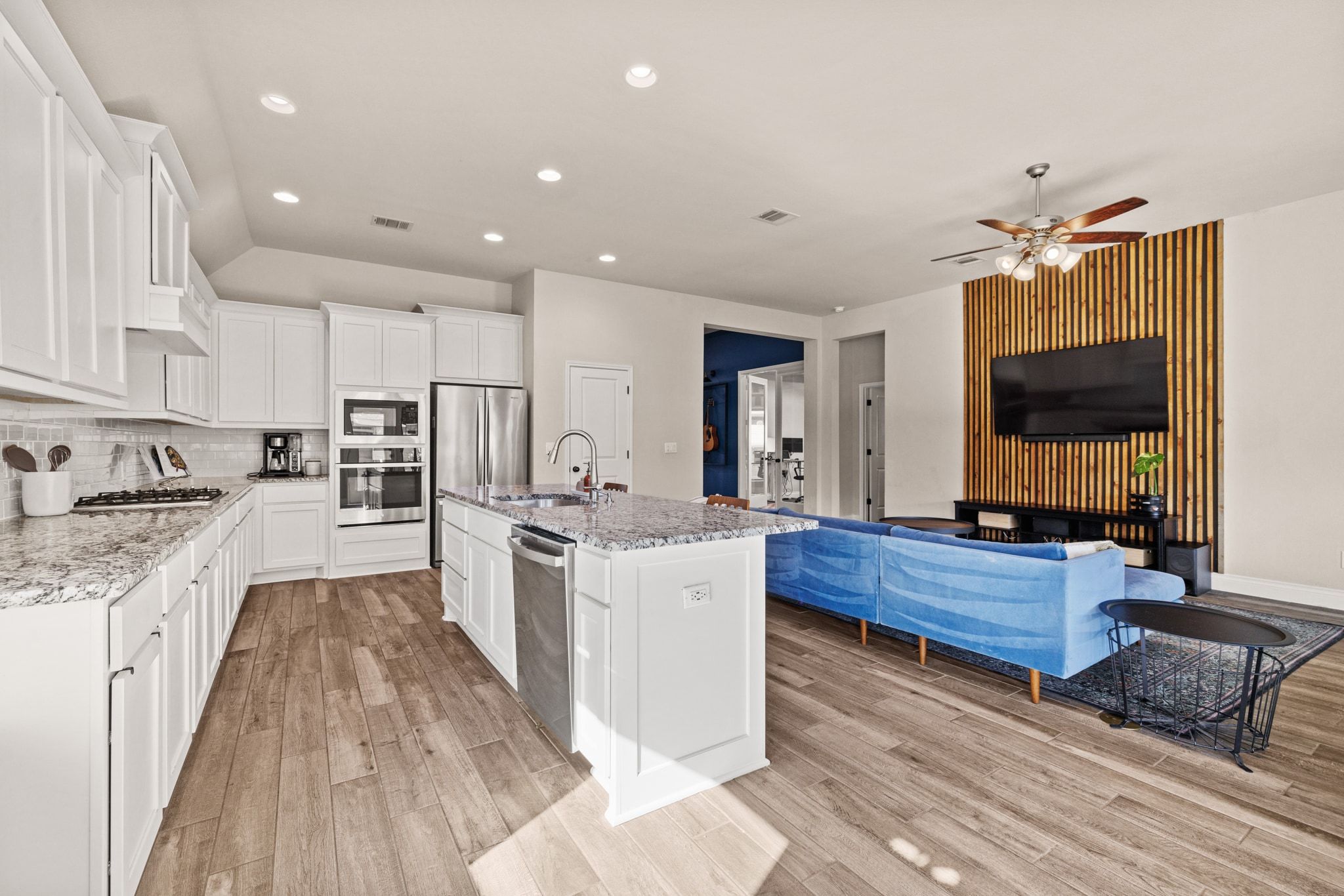 1136 Stetson Hat Trail Georgetown, TX 78628 - Photo 8 of 40 a large kitchen with stainless steel appliances granite countertop a stove oven and a white cabinets with wooden floor