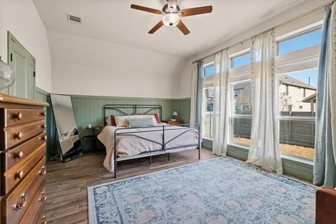 a bedroom with a bed and a chandelier