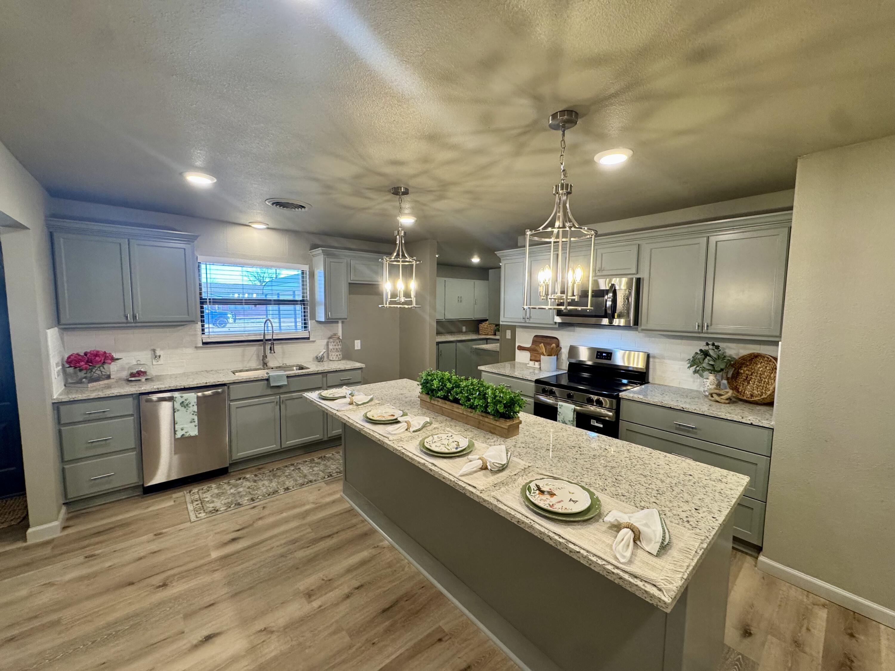 106 North 22nd Place Lamesa, TX 79331 - Photo 1 of 82 a kitchen with stainless steel appliances granite countertop a sink refrigerator and cabinets