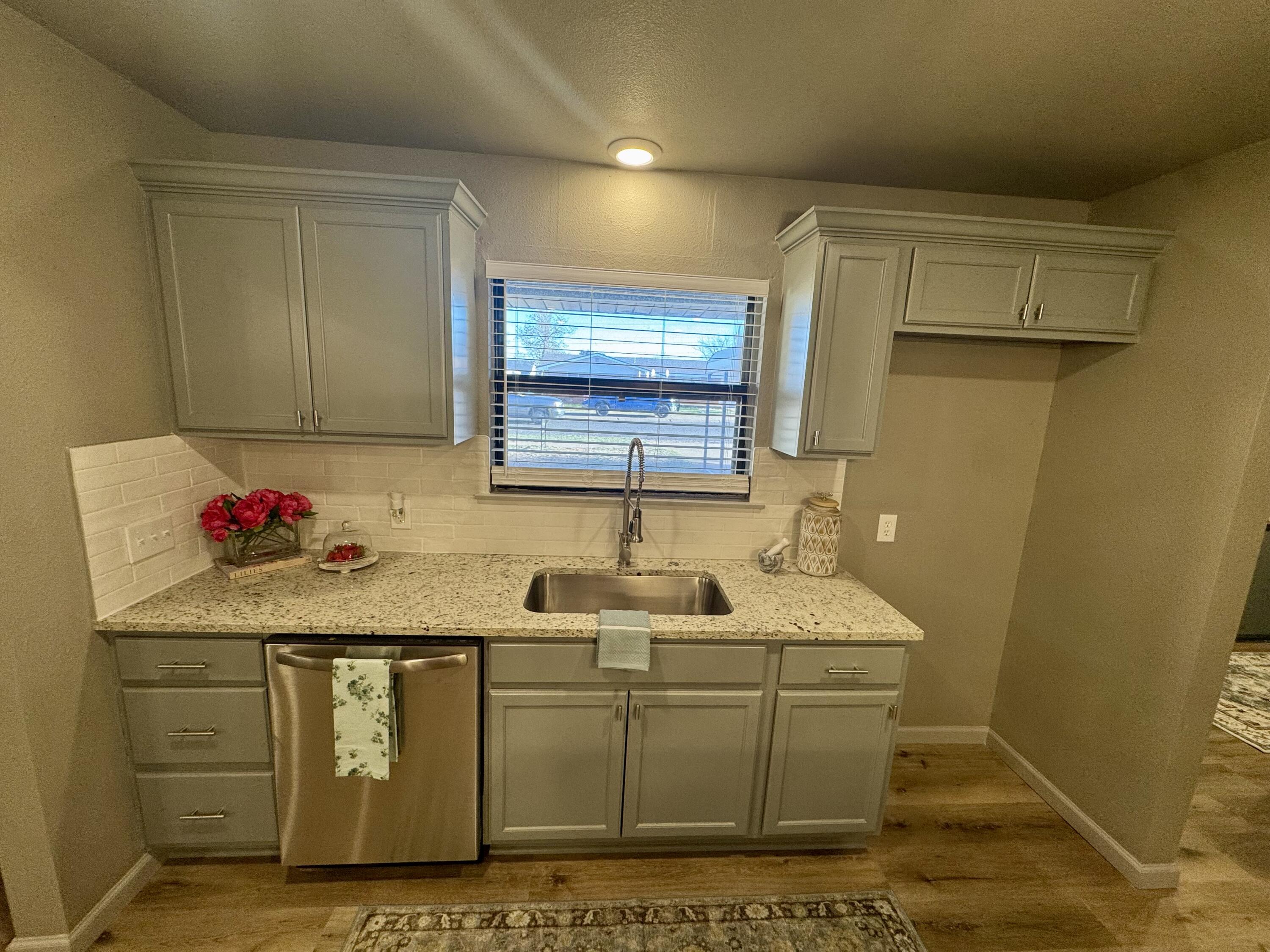 106 North 22nd Place Lamesa, TX 79331 - Photo 11 of 82 a room with granite countertop cabinets and sink