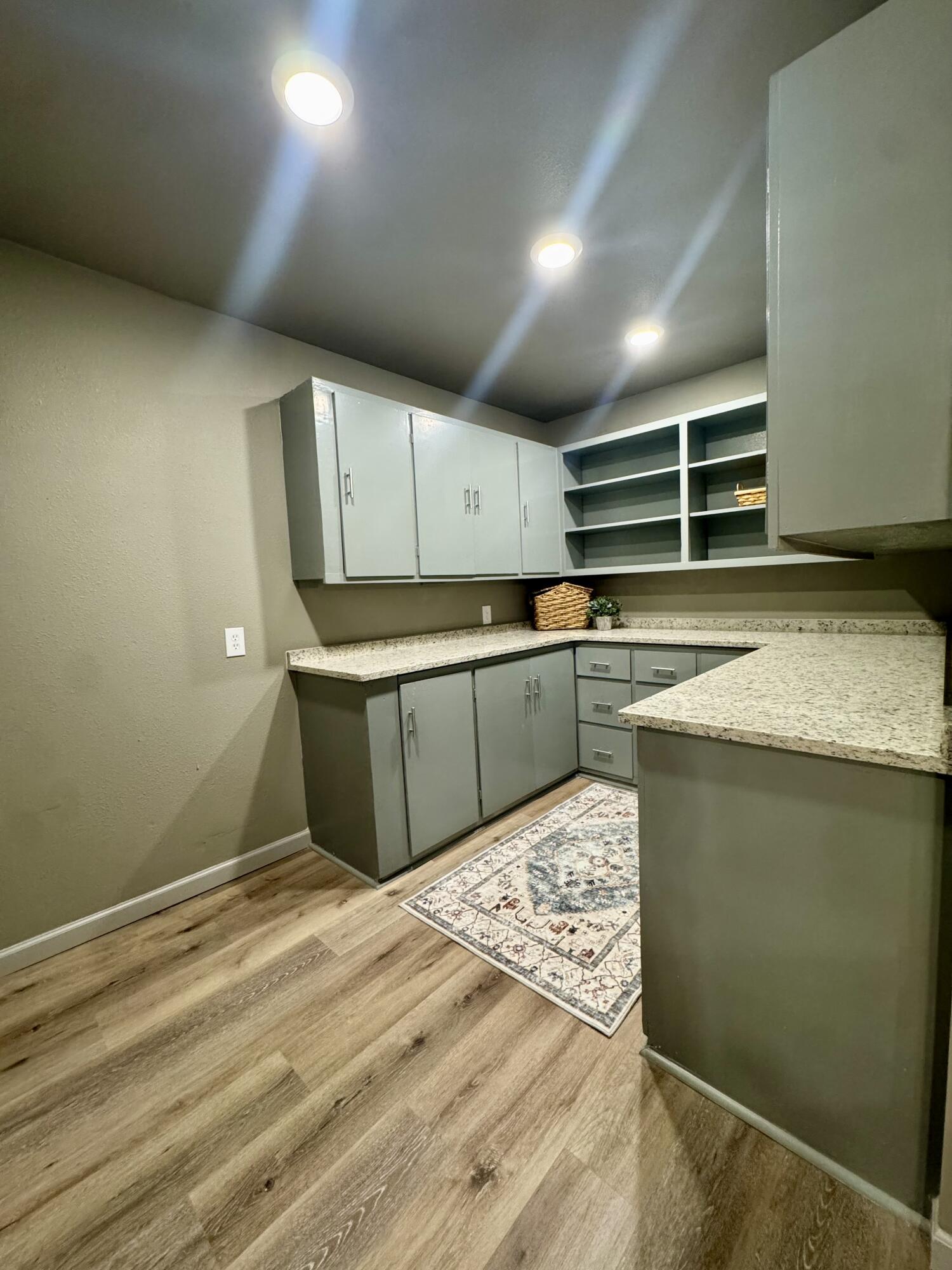 106 North 22nd Place Lamesa, TX 79331 - Photo 19 of 82 a kitchen with stainless steel appliances granite countertop a sink stove and cabinets