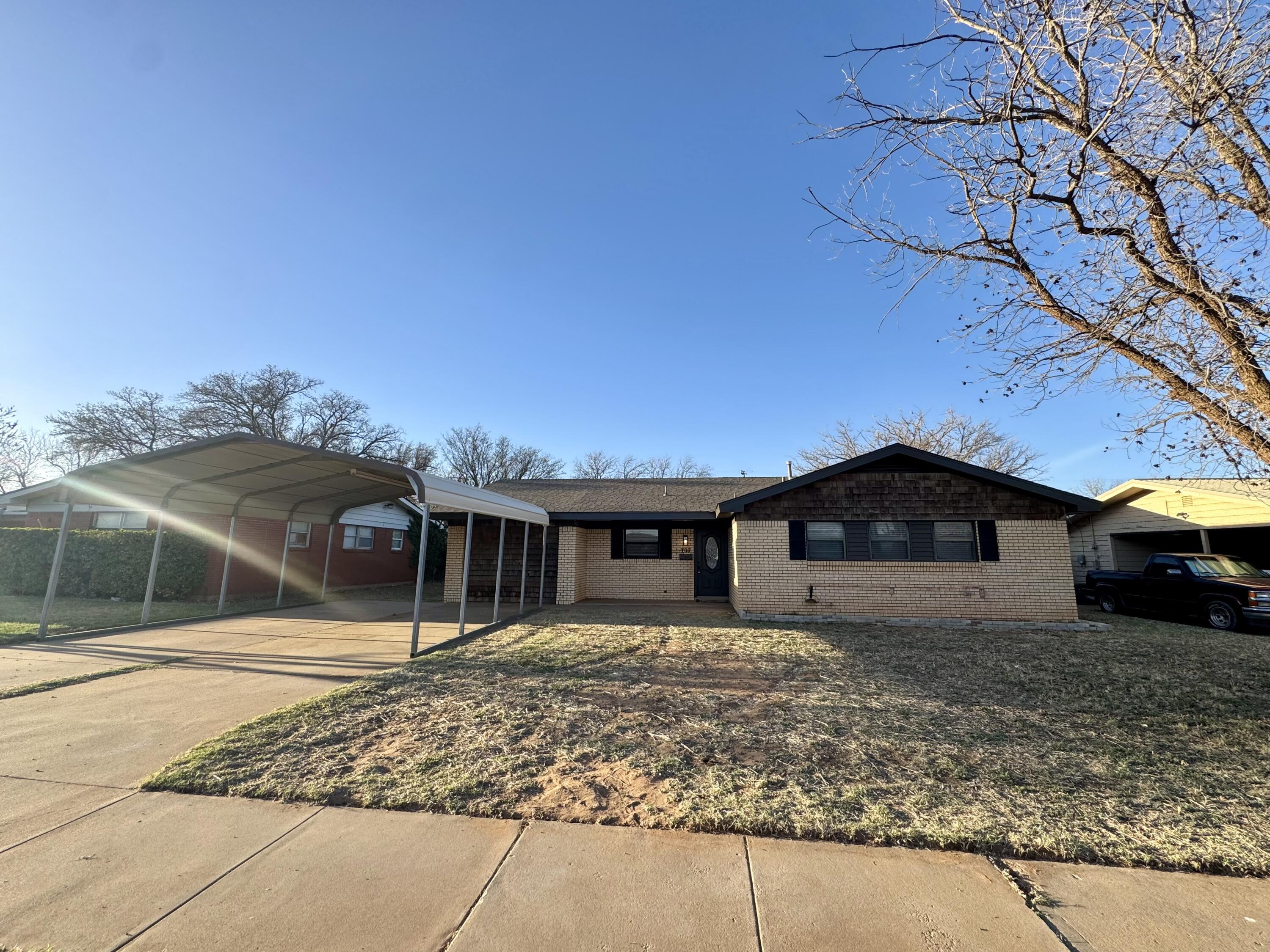 106 North 22nd Place Lamesa, TX 79331 - Photo 2 of 82 a front view of a house with a yard