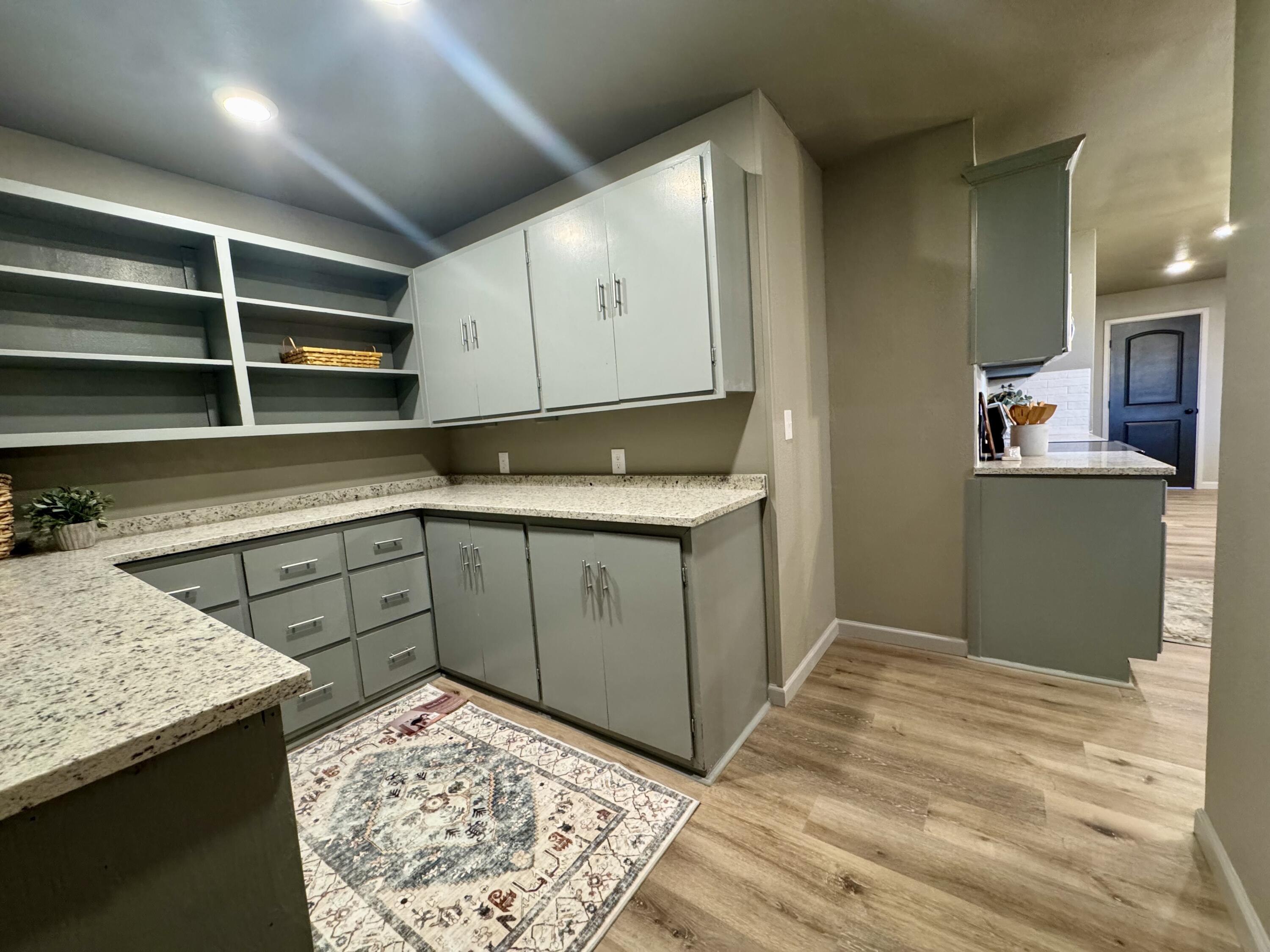 106 North 22nd Place Lamesa, TX 79331 - Photo 24 of 82 a kitchen with stainless steel appliances granite countertop a sink stove and cabinets