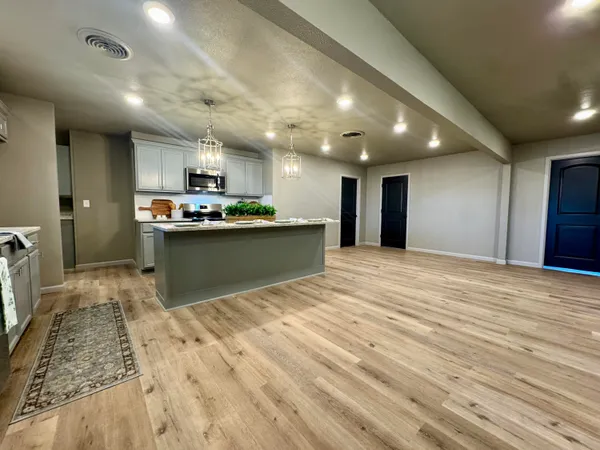 a stove top oven sitting inside of a kitchen