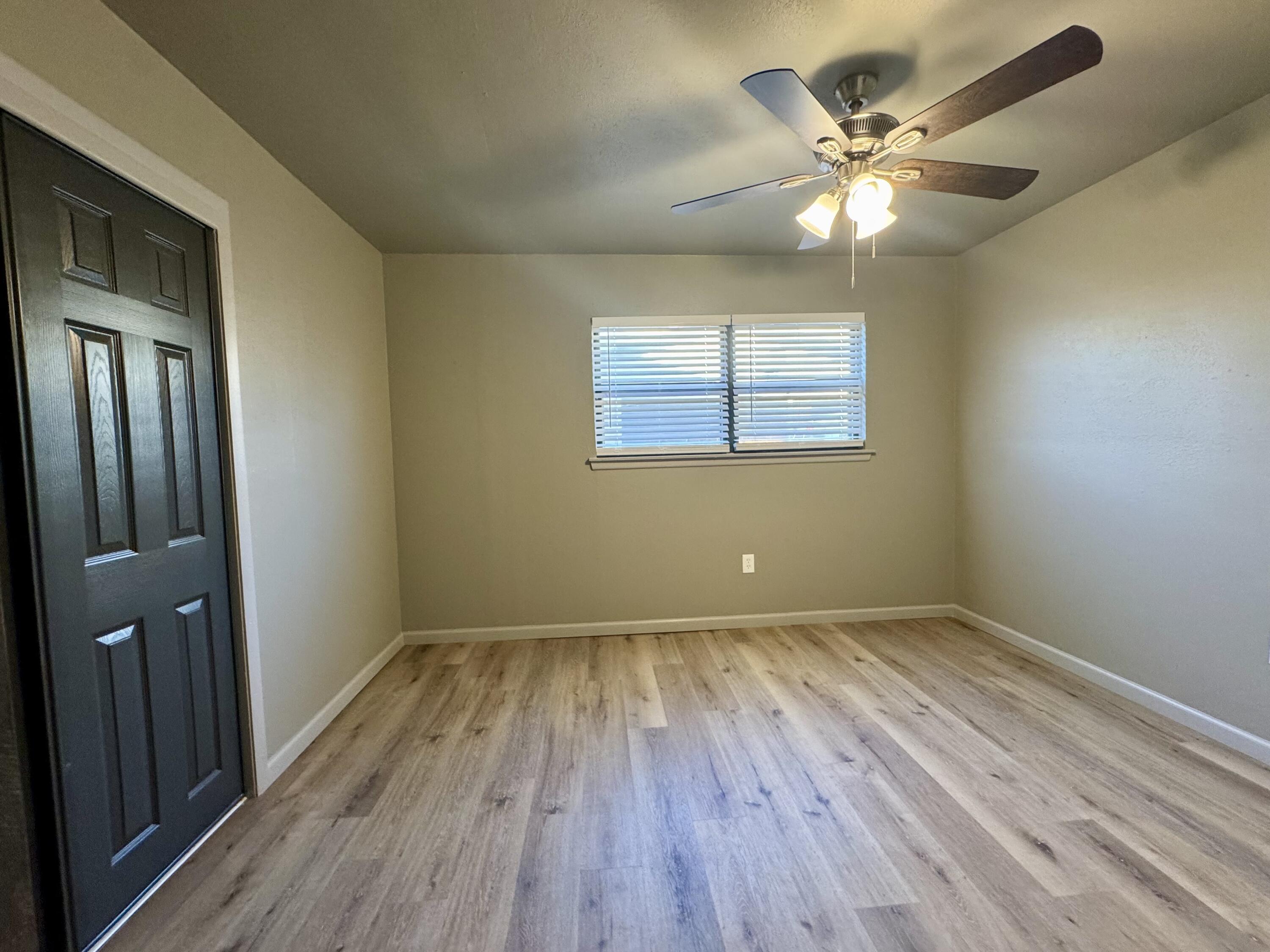 106 North 22nd Place Lamesa, TX 79331 - Photo 47 of 82 wooden floor in an empty room with a mirror