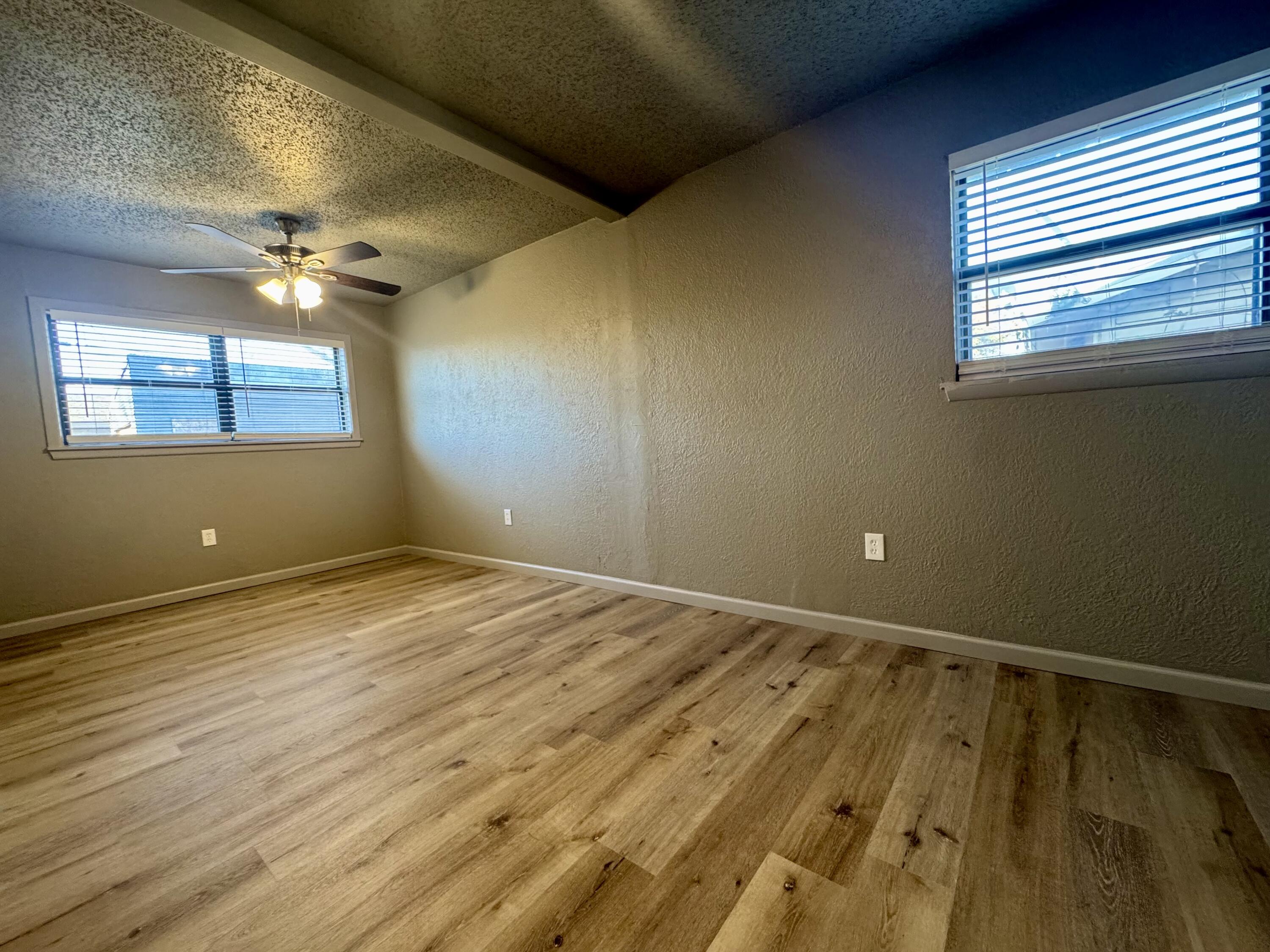 106 North 22nd Place Lamesa, TX 79331 - Photo 51 of 82 a view of an empty room and window and chandelier fan