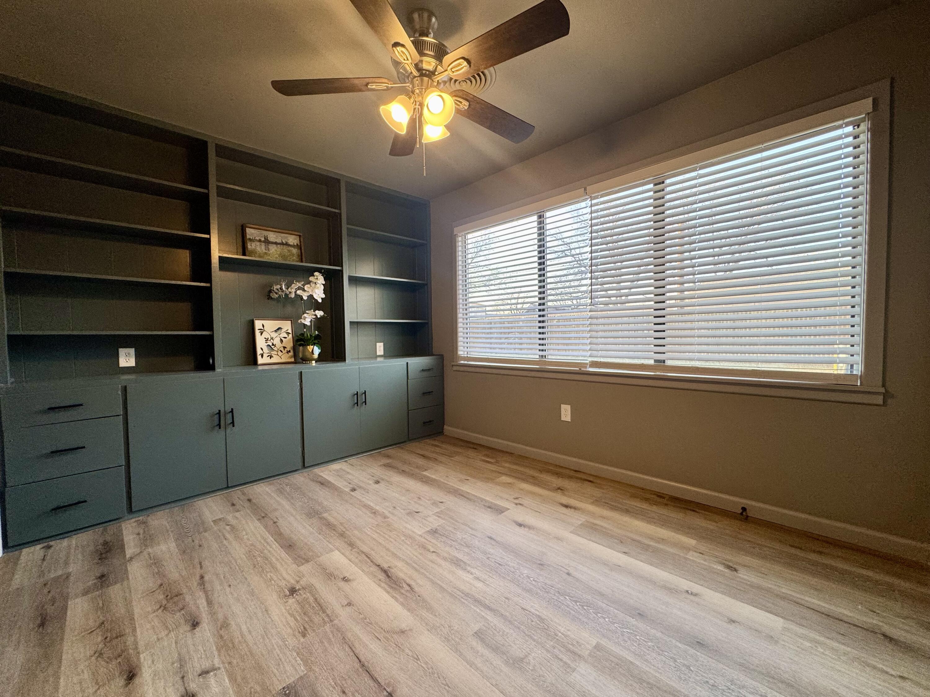 106 North 22nd Place Lamesa, TX 79331 - Photo 56 of 82 a view of an empty room with a window and wooden floor