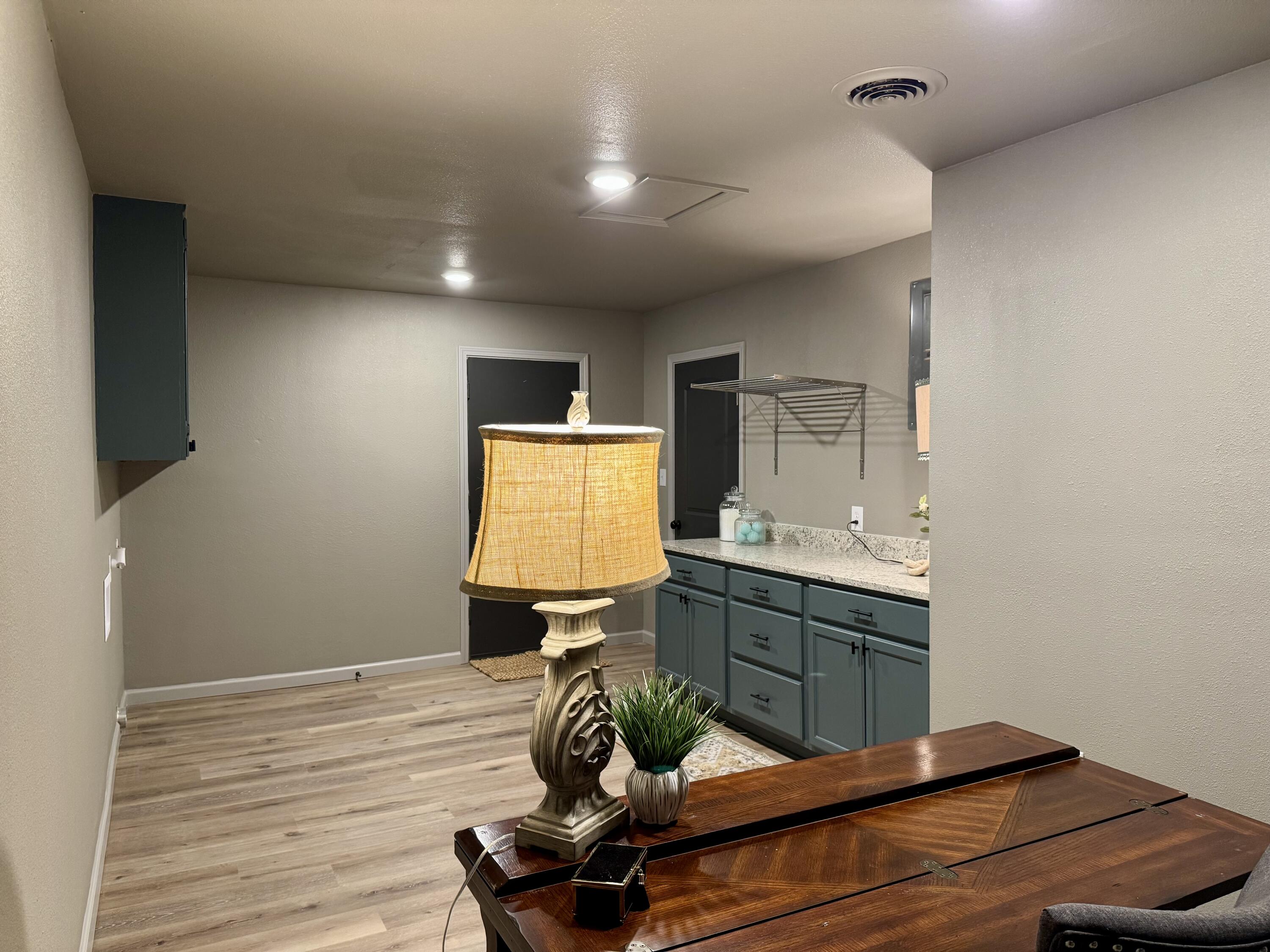 106 North 22nd Place Lamesa, TX 79331 - Photo 72 of 82 a room with table chairs flat screen tv and wooden floor
