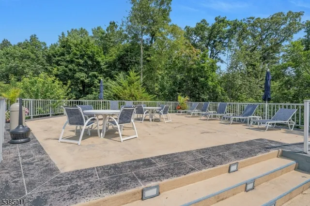 swimming pool view with a seating space