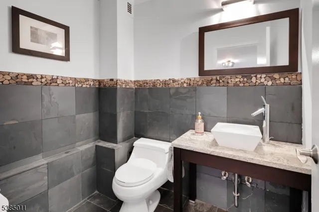a bathroom with a sink toilet and mirror