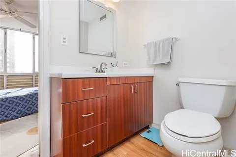 a bathroom with a toilet a sink and mirror