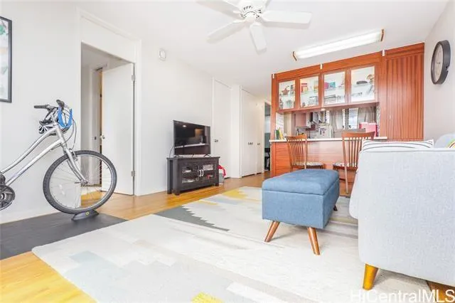 a living room with furniture a flat screen tv and a window