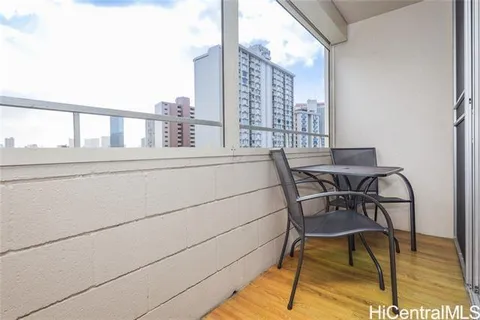 a view of a chair and table in the balcony